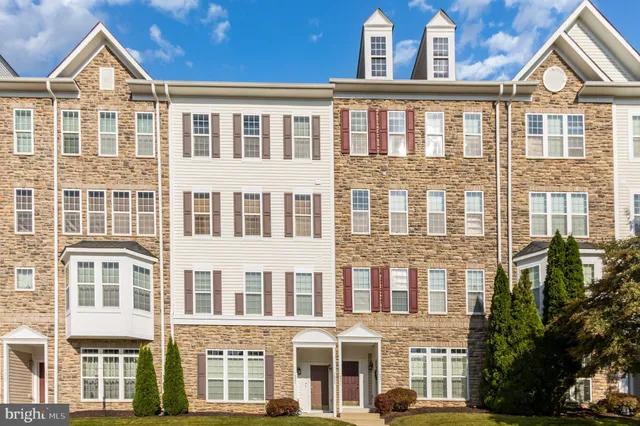 a view of a brick building next to a yard