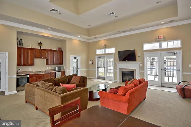 a living room with furniture a flat screen tv and a fireplace