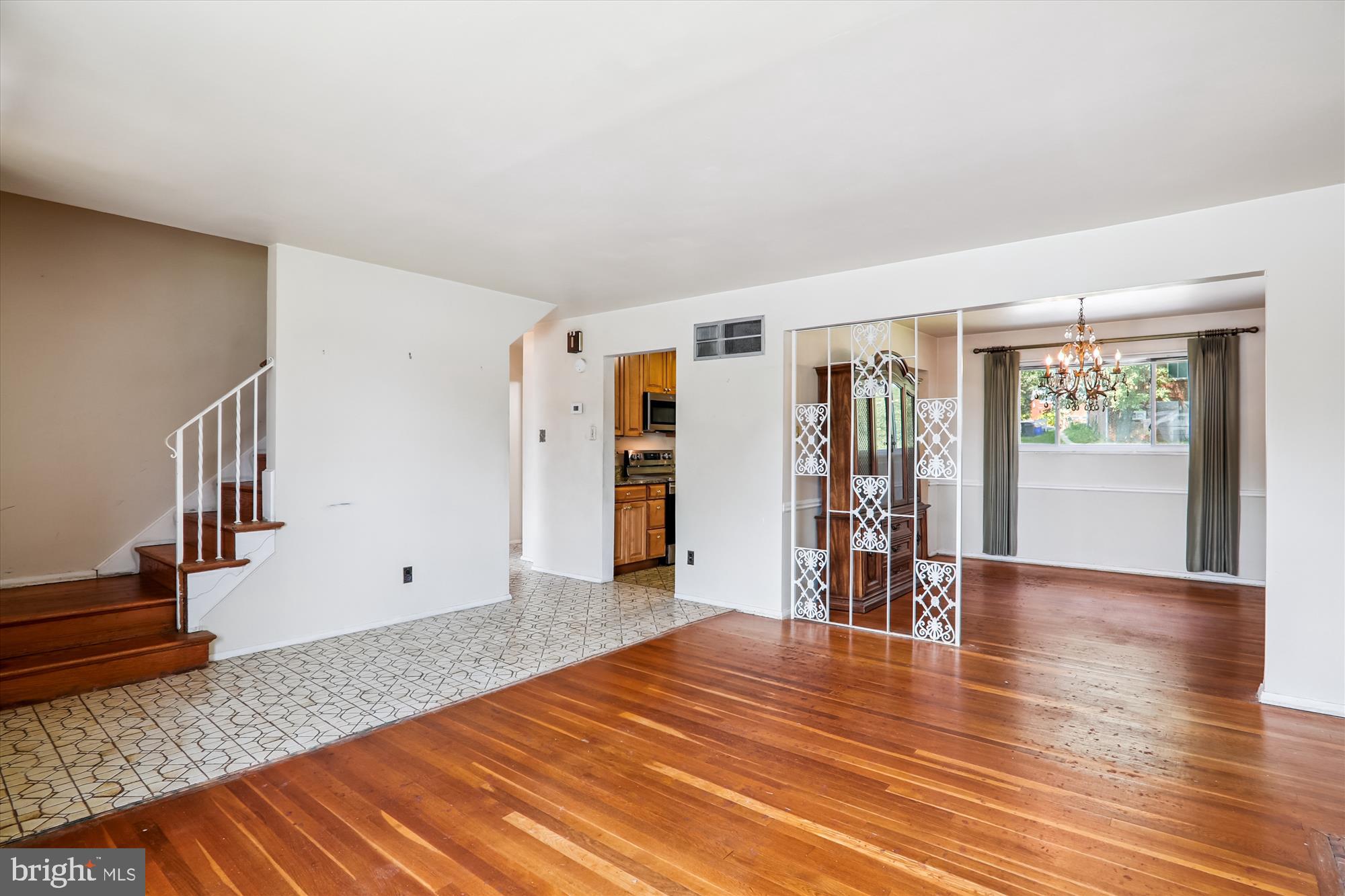 9507 Adelphi Road Silver Spring, MD 20903 - Photo 6 of 41 a view of an empty room with wooden floor and a window