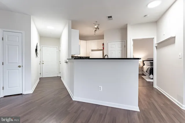 a view of a kitchen with wooden floor