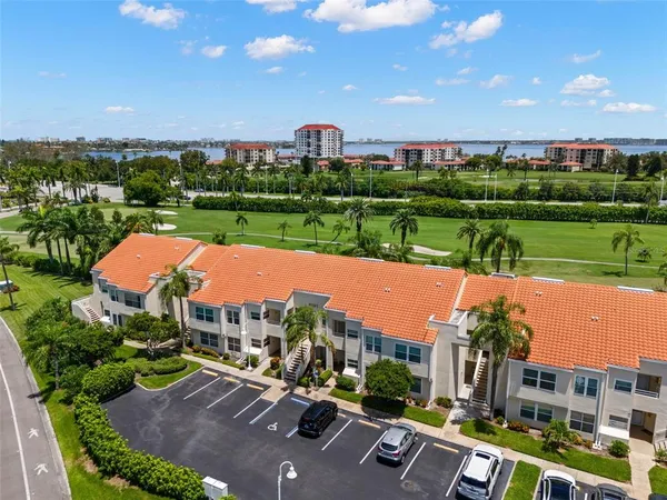 an aerial view of houses with yard and lake view