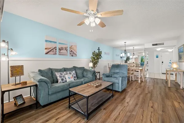 a living room with furniture and a wooden floor