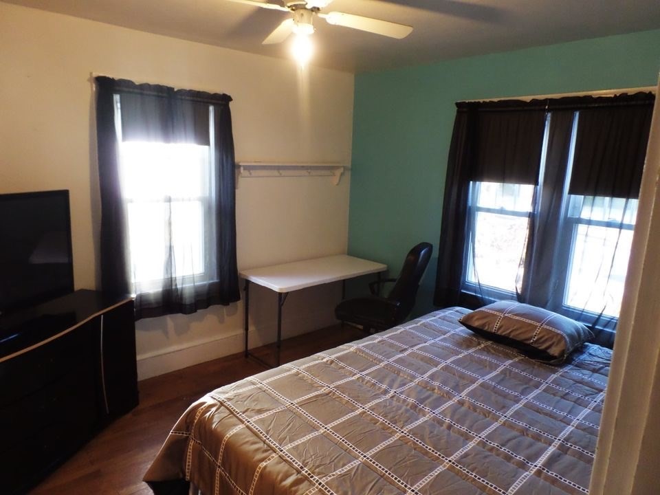 12 Carroll Street Springfield, MA 01108 - Photo 8 of 13 a bedroom with a bed and a window