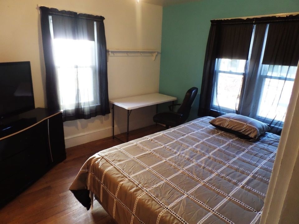 12 Carroll Street Springfield, MA 01108 - Photo 10 of 13 a bedroom with a bed and a window