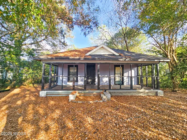 a front view of a house with a yard table and chairs