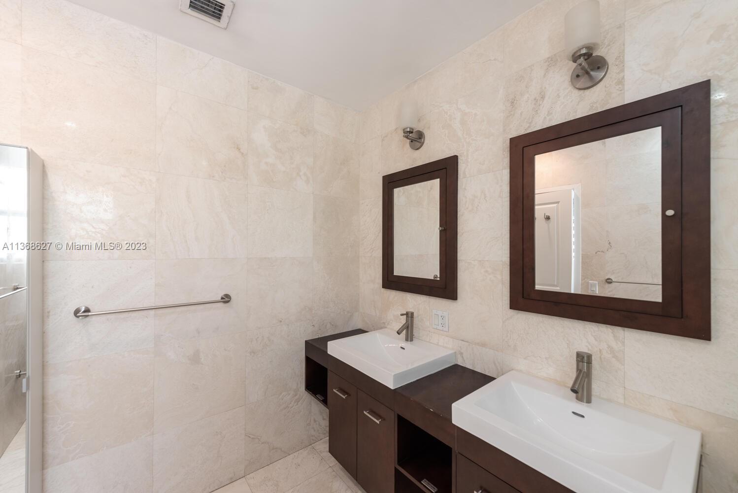 265 Ridgewood Road Key Biscayne, FL 33149 - Photo 13 of 25 a bathroom with a double vanity sink mirror and