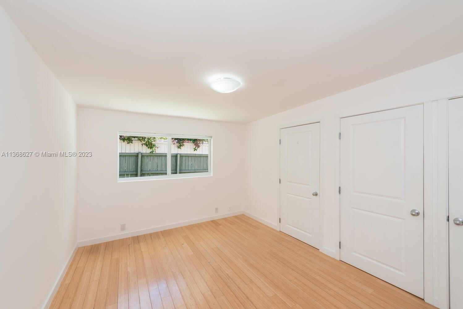 265 Ridgewood Road Key Biscayne, FL 33149 - Photo 14 of 25 a view of an empty room with wooden floor and a window