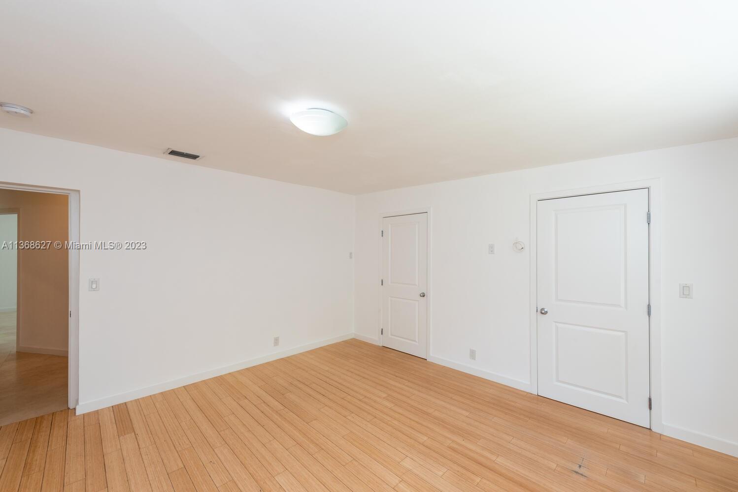 265 Ridgewood Road Key Biscayne, FL 33149 - Photo 17 of 25 a view of empty room with wooden floor