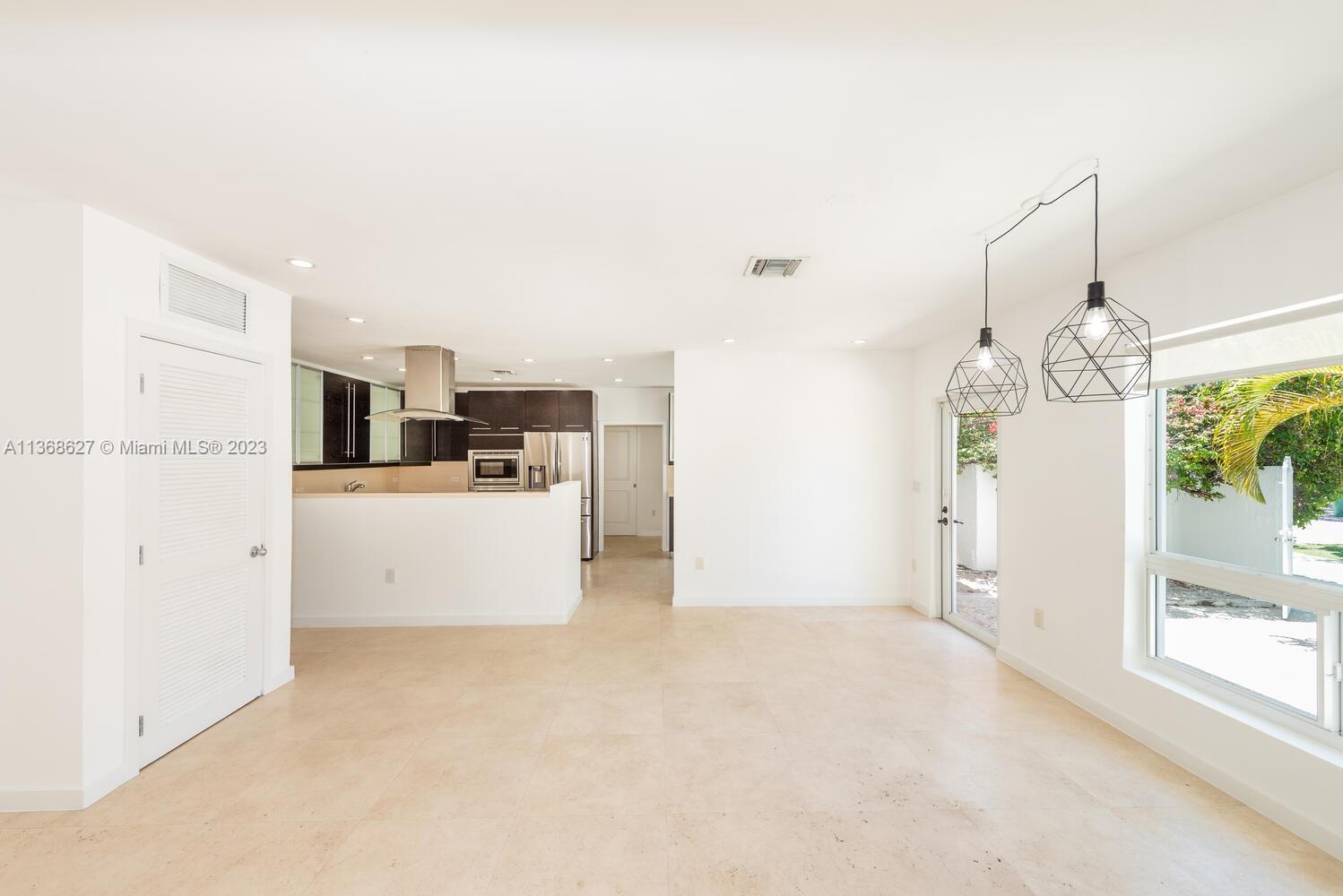 265 Ridgewood Road Key Biscayne, FL 33149 - Photo 2 of 25 a view of a kitchen and a windows