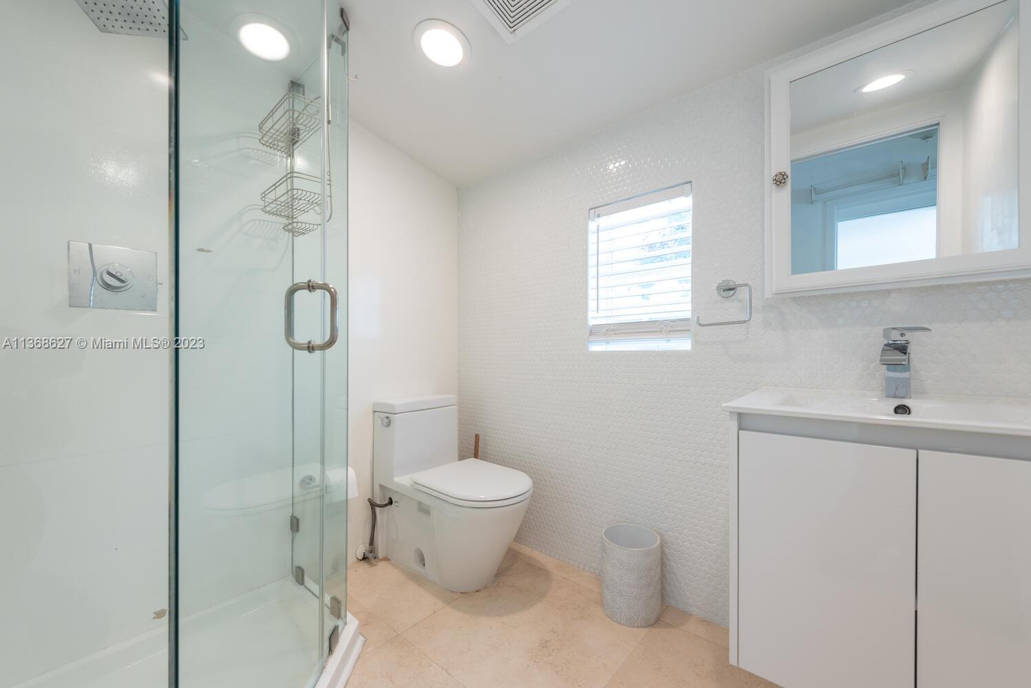 265 Ridgewood Road Key Biscayne, FL 33149 - Photo 23 of 25 a bathroom with a toilet sink and shower