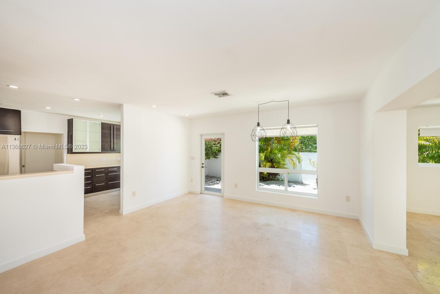 265 Ridgewood Road Key Biscayne, FL 33149 - Photo 3 of 25 an empty room with windows and fireplace