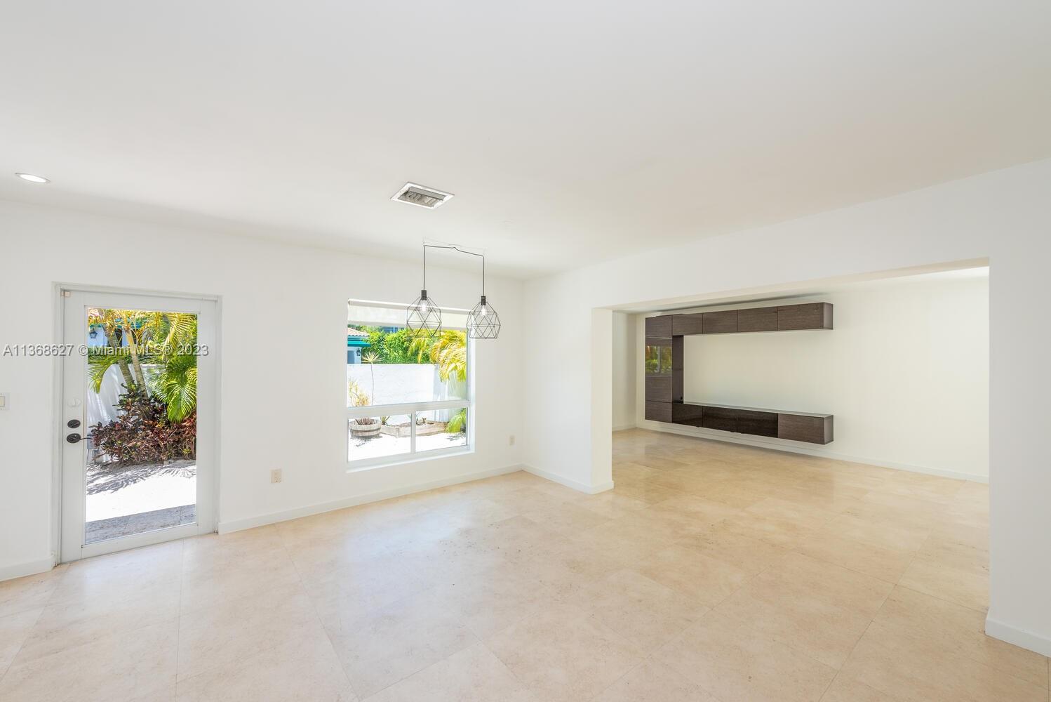 265 Ridgewood Road Key Biscayne, FL 33149 - Photo 4 of 25 an empty room with windows and mountain view