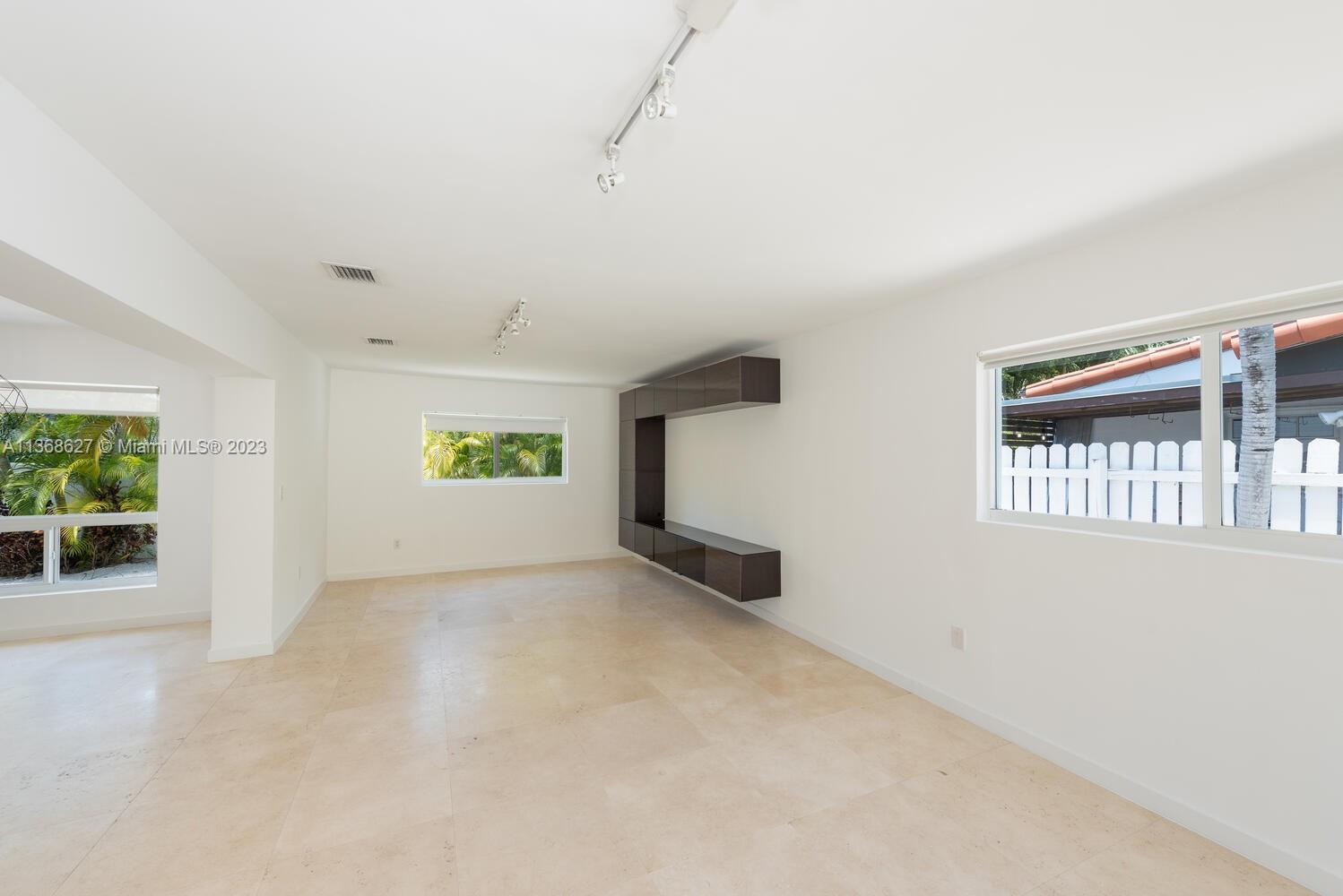 265 Ridgewood Road Key Biscayne, FL 33149 - Photo 5 of 25 an empty room with windows