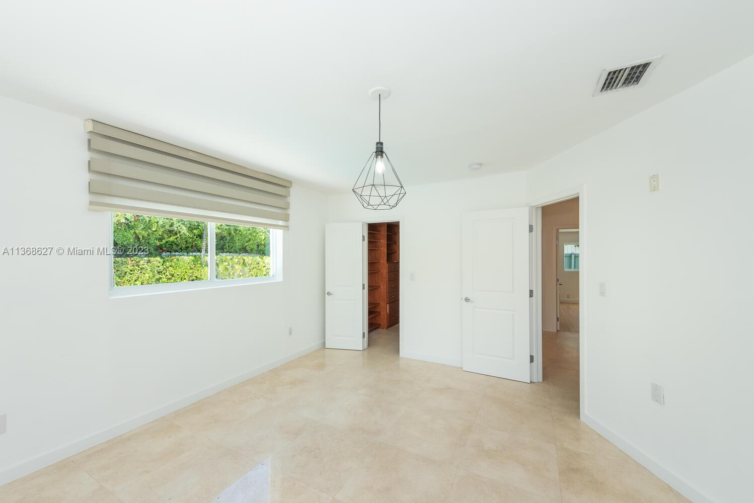 265 Ridgewood Road Key Biscayne, FL 33149 - Photo 10 of 25 a view of a room with large windows and a chandelier