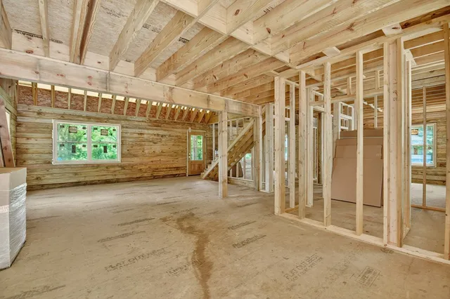 a view of a room with trees in the background