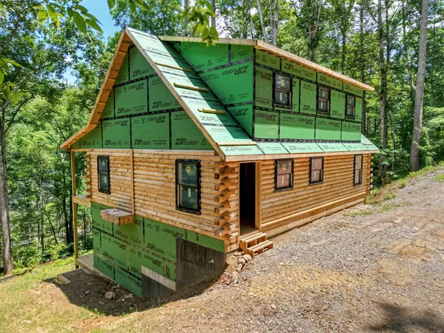 a view of a small house with a yard