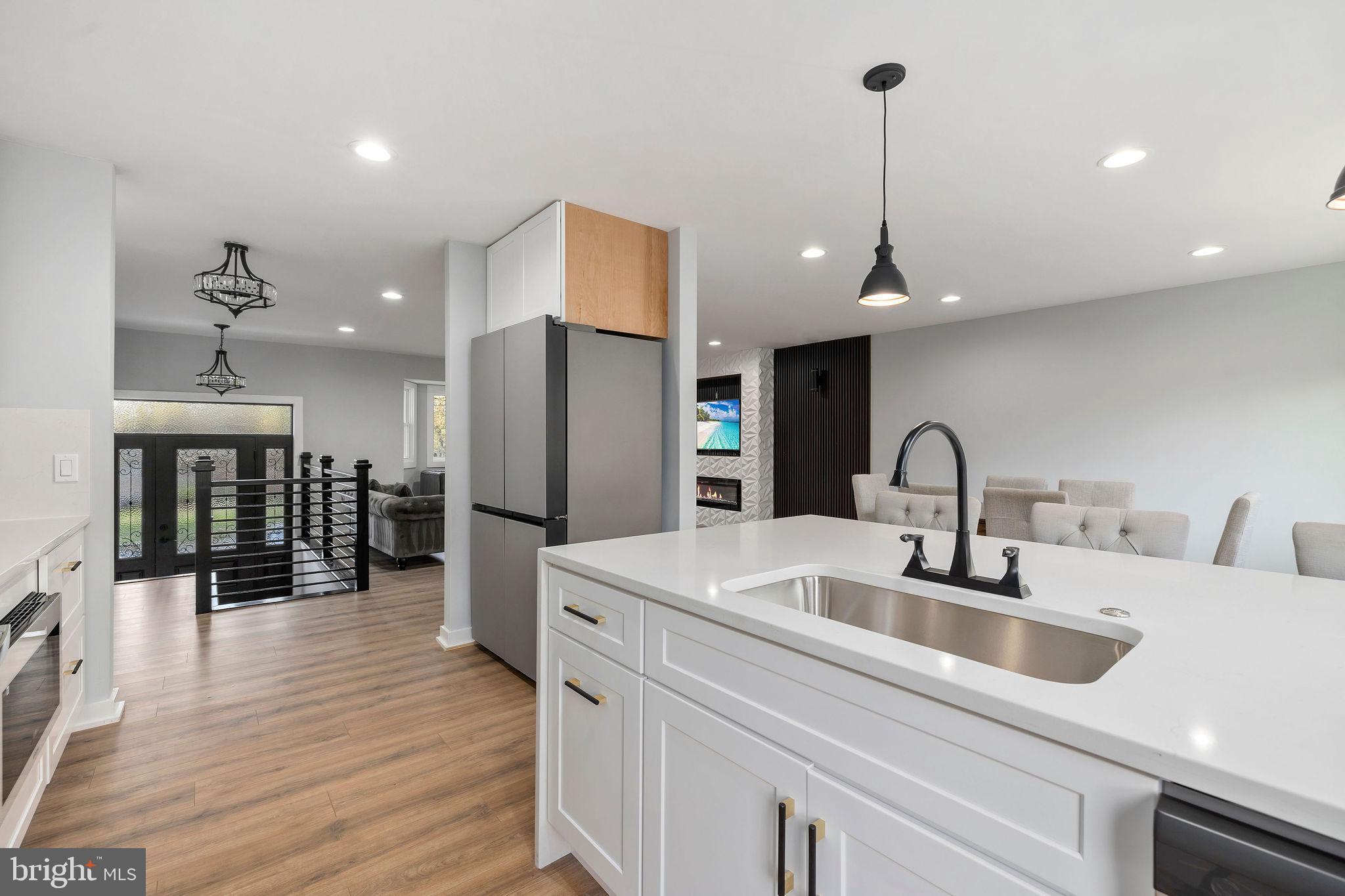 2209 Ellis Street Silver Spring, MD 20910 - Photo 13 of 49 a kitchen with stainless steel appliances a refrigerator sink and wooden floor