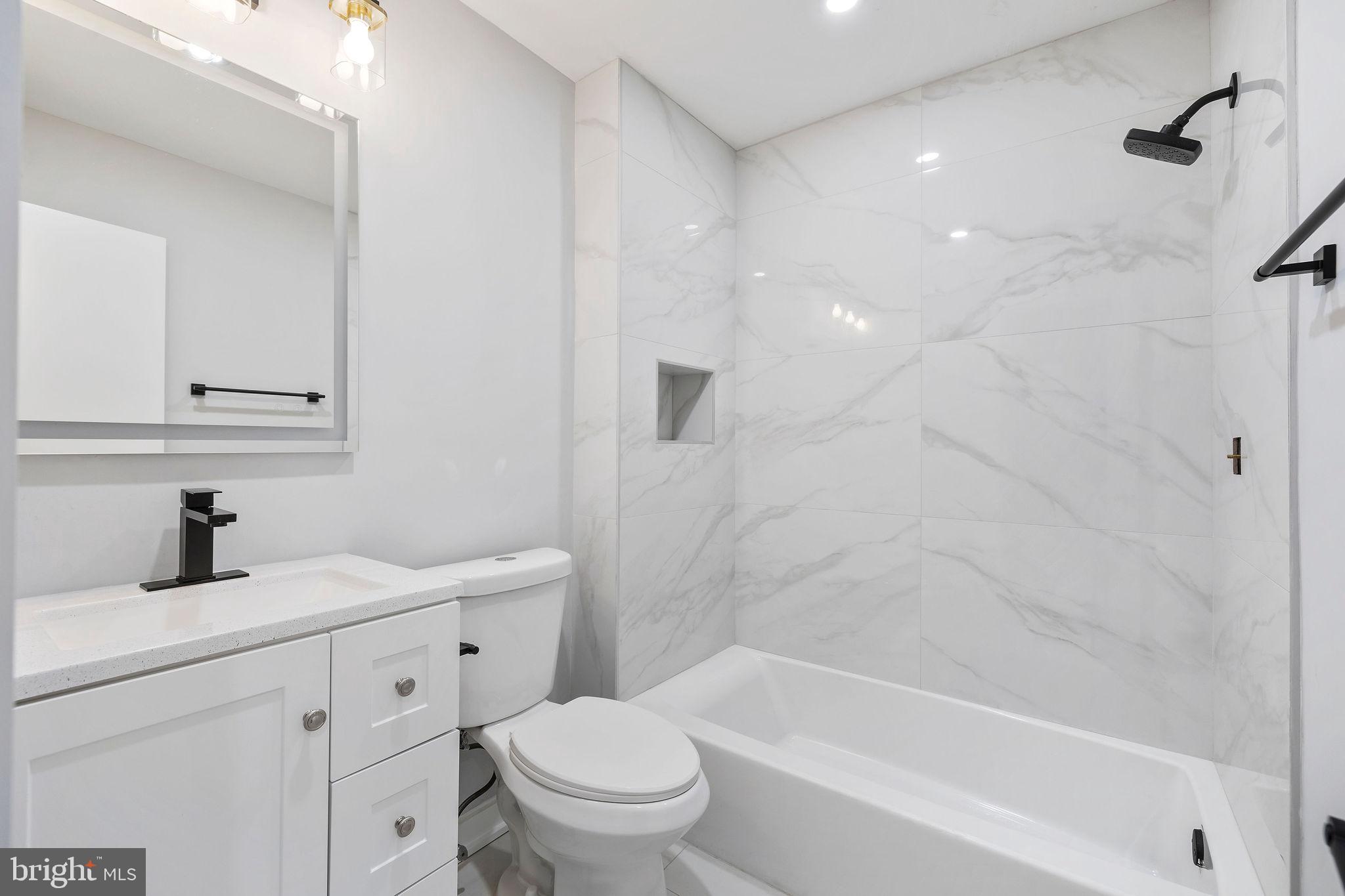 2209 Ellis Street Silver Spring, MD 20910 - Photo 14 of 49 a bathroom with a sink a toilet and a bathtub