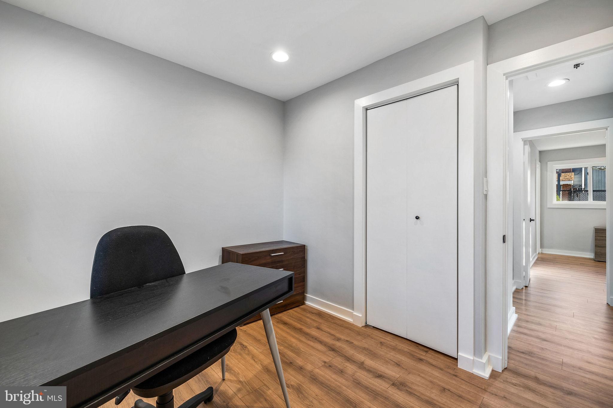 2209 Ellis Street Silver Spring, MD 20910 - Photo 23 of 49 a workspace with wooden floor and a cabinet