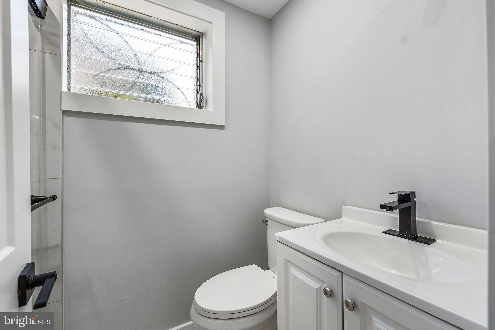 2209 Ellis Street Silver Spring, MD 20910 - Photo 32 of 49 a bathroom with a sink a toilet and a window