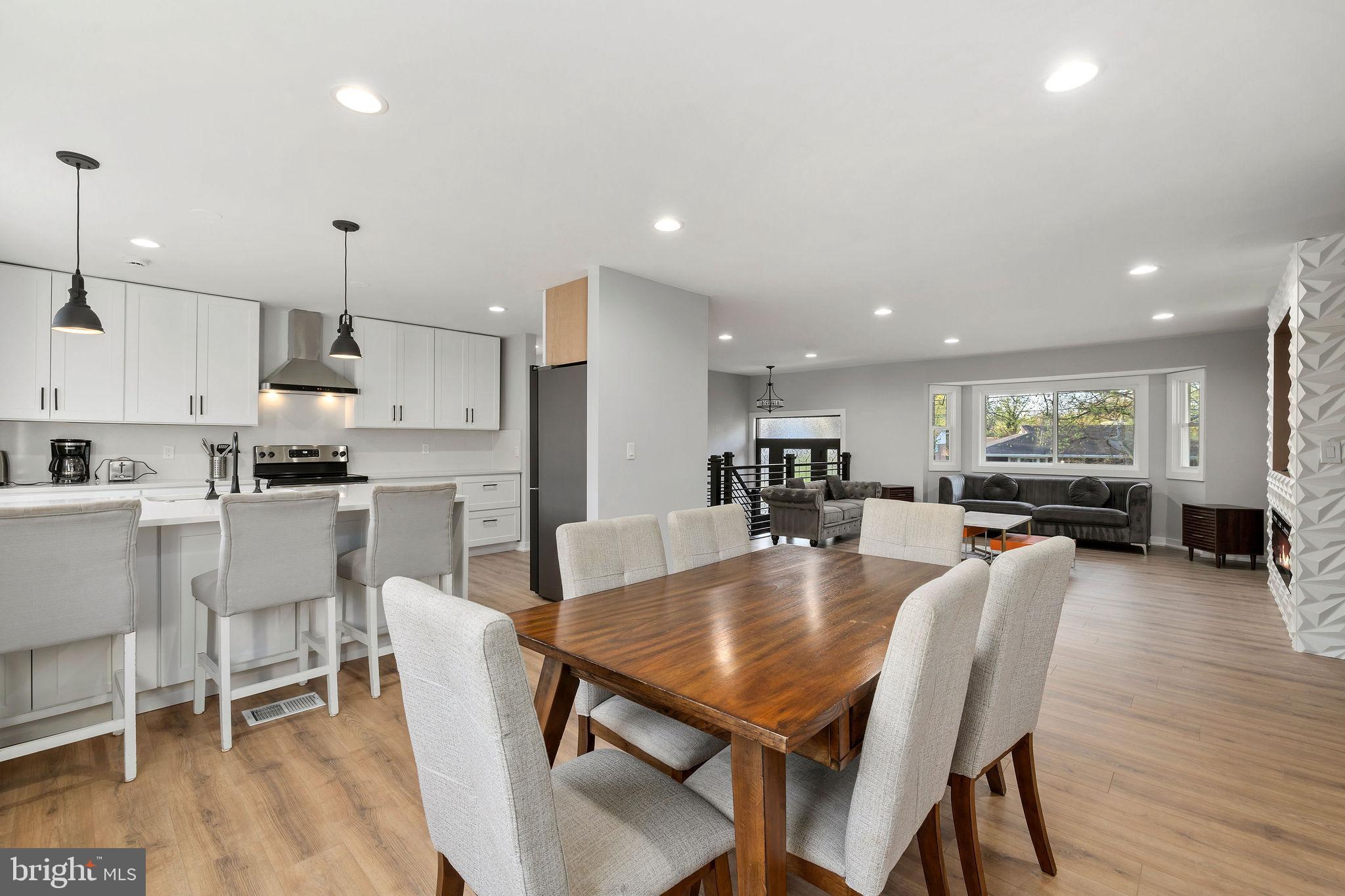 2209 Ellis Street Silver Spring, MD 20910 - Photo 8 of 49 a dining room with furniture a wooden floor and kitchen view
