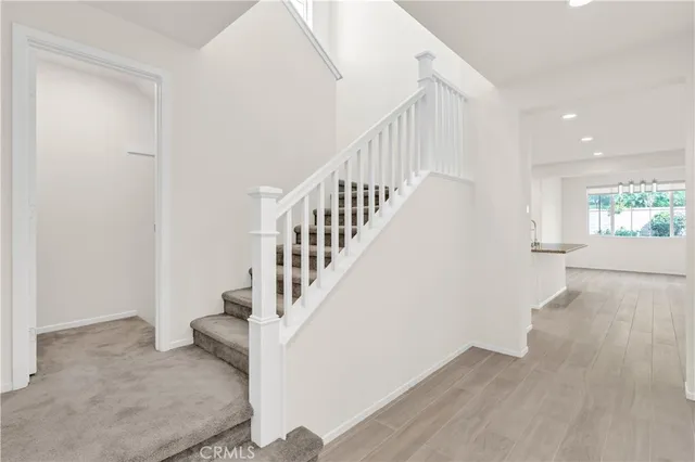 a white toilet sitting next to a white wall