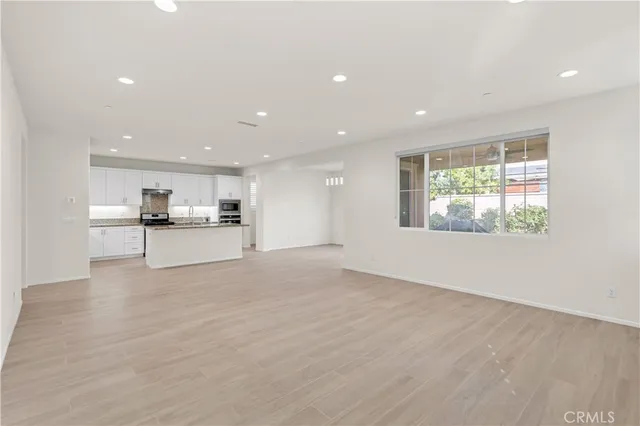 a kitchen with granite countertop white cabinets and appliances