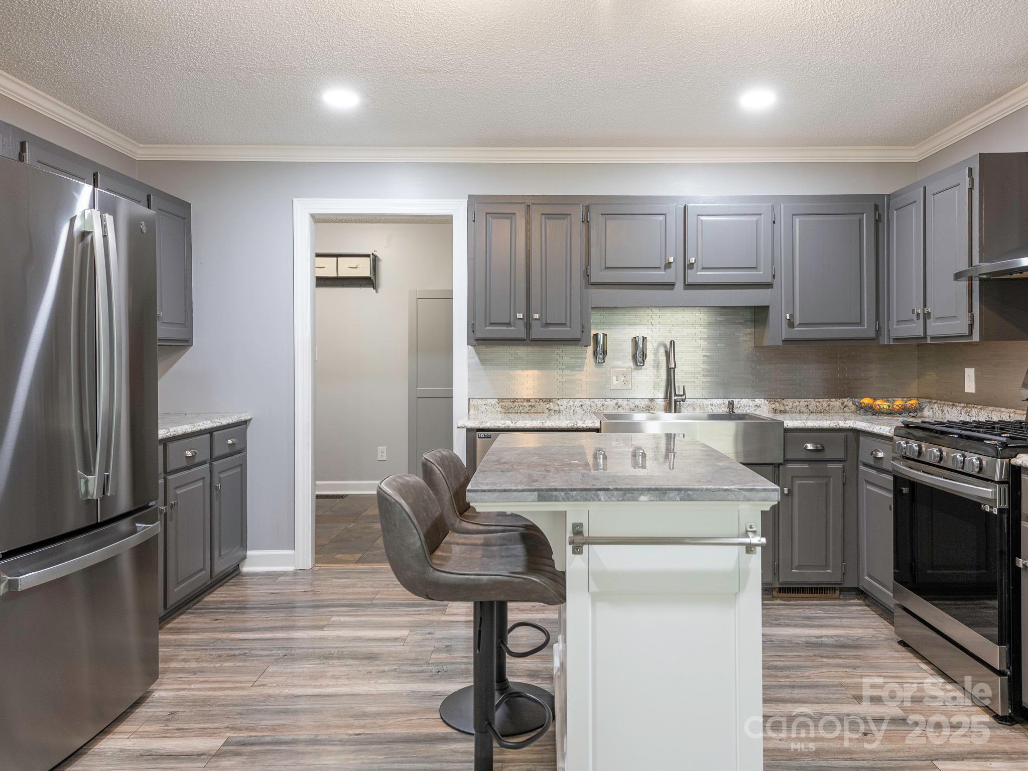 3022 Crestview Lane Lancaster, SC 29720 - Photo 13 of 46 a kitchen with stainless steel appliances granite countertop a stove a refrigerator and a microwave
