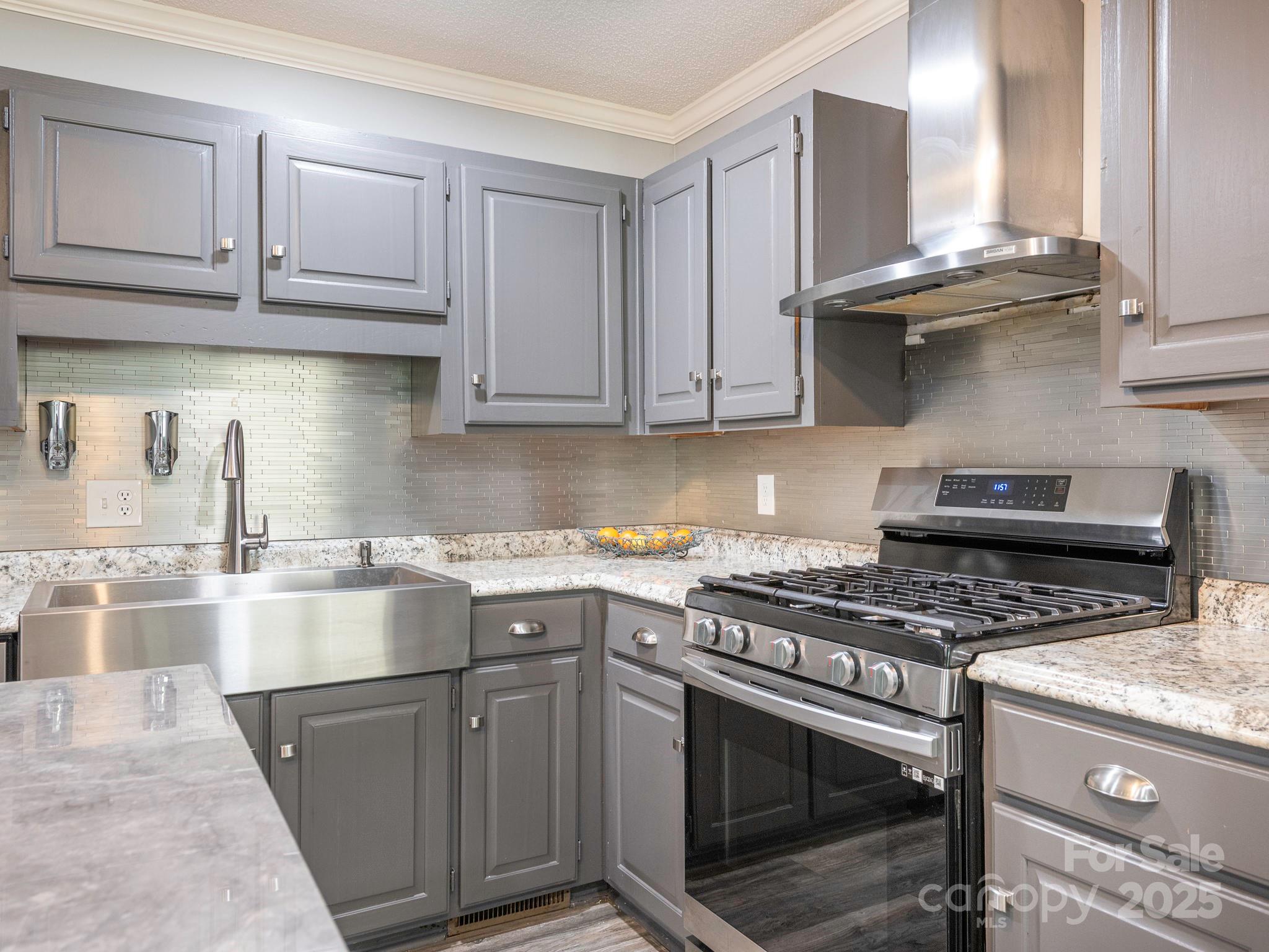 3022 Crestview Lane Lancaster, SC 29720 - Photo 15 of 46 a kitchen with stainless steel appliances granite countertop a stove a sink dishwasher and cabinets with wooden floor