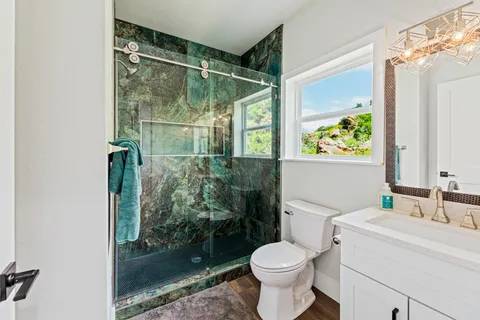 a bathroom with a toilet sink and shower