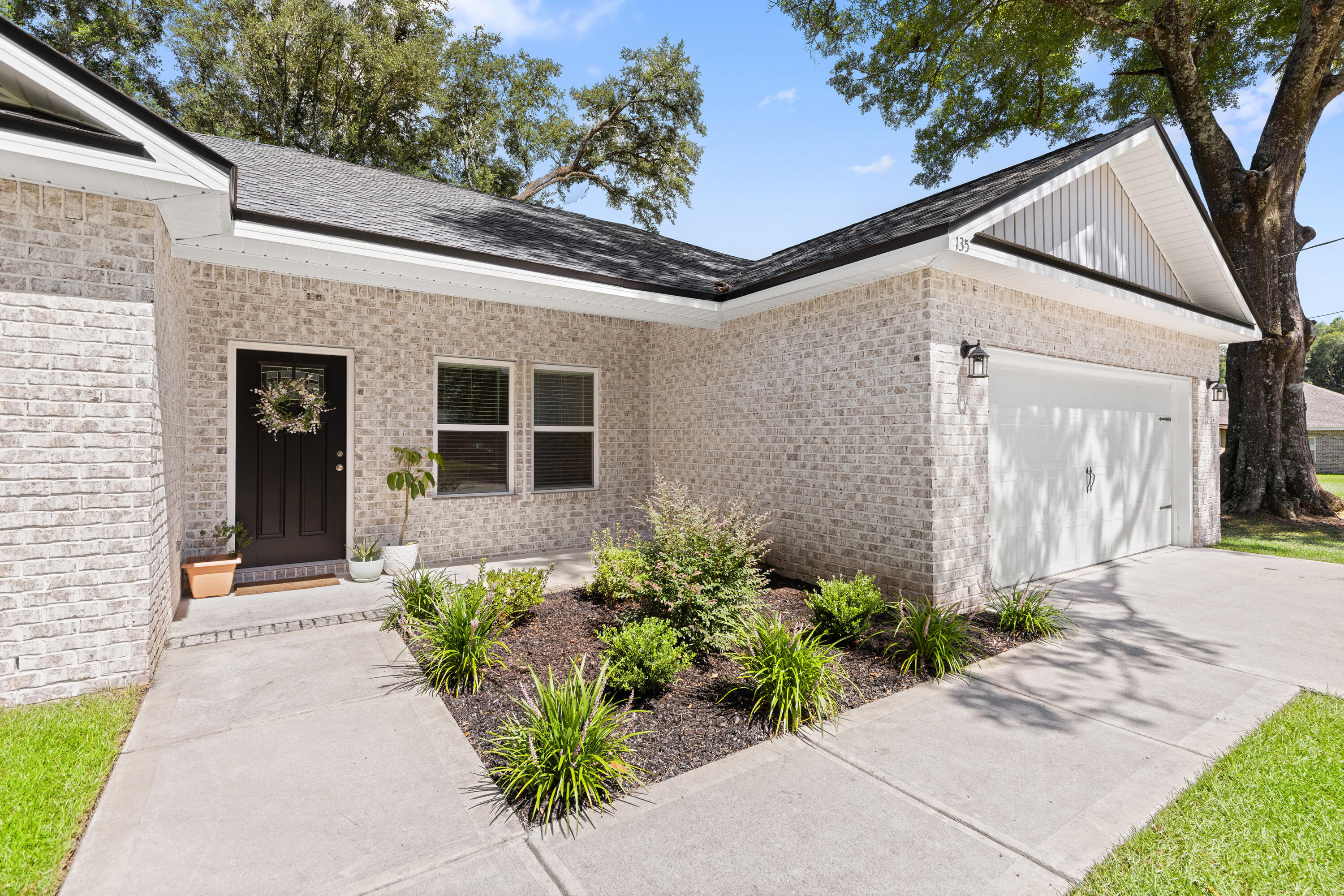135 Shady Lane Crestview, FL 32536 - Photo 5 of 36 a front view of a house with garden
