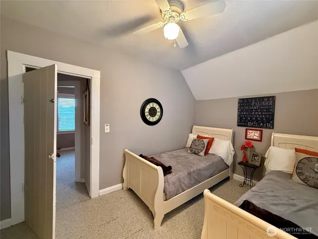 a bedroom with bed and a chandelier