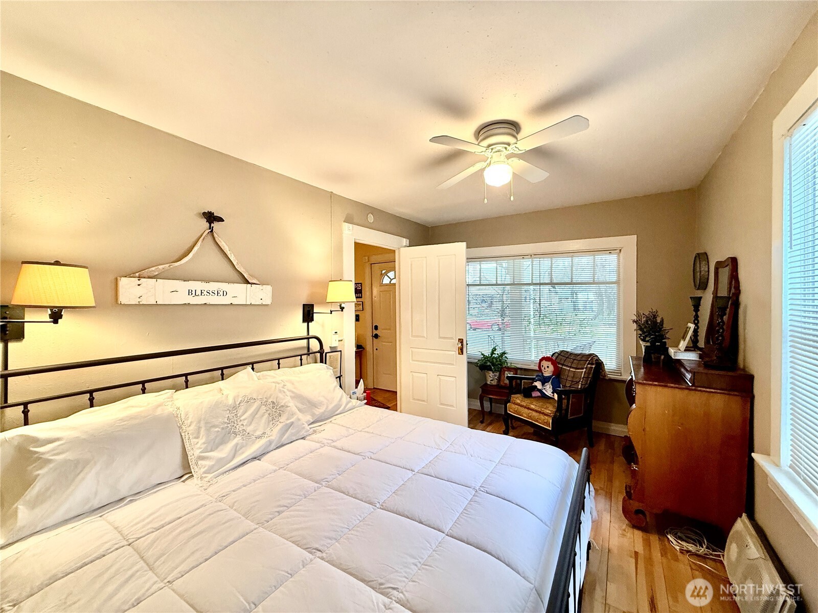 213 East Oak Street Dayton, WA 99328 - Photo 6 of 27 a bed room with a bed and a chandelier