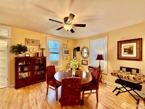 a view of a dining room with furniture and wooden floor