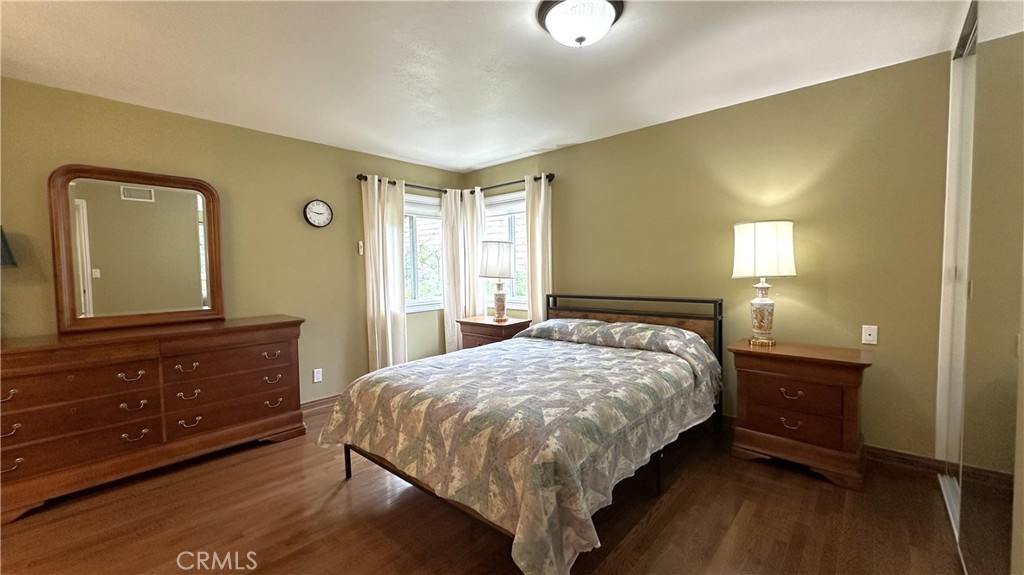 12111 Eddleston Drive Porter Ranch, CA 91326 - Photo 12 of 31 a bedroom with a bed and a dresser with mirror
