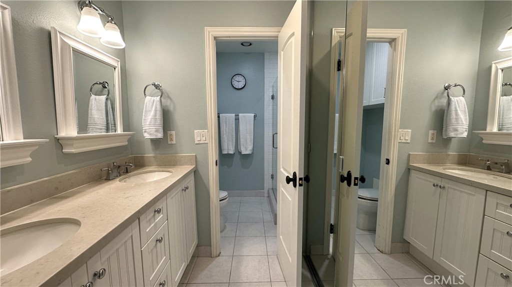 12111 Eddleston Drive Porter Ranch, CA 91326 - Photo 14 of 31 a bathroom with a granite countertop sink and a mirror