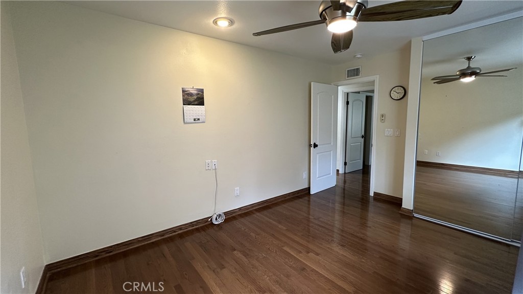 12111 Eddleston Drive Porter Ranch, CA 91326 - Photo 16 of 31 an empty room with wooden floor closet and windows