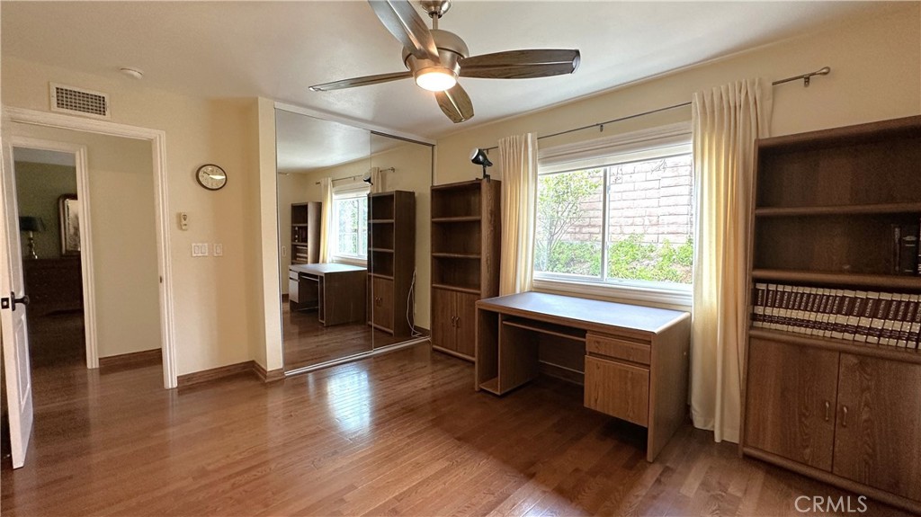 12111 Eddleston Drive Porter Ranch, CA 91326 - Photo 17 of 31 a view of a kitchen with a fridge wooden floor and a window