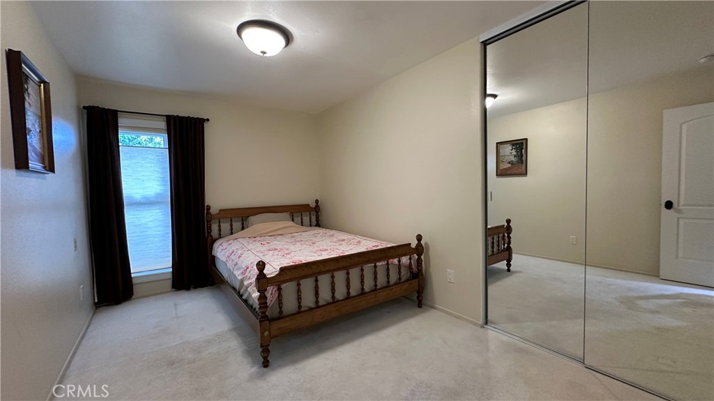 12111 Eddleston Drive Porter Ranch, CA 91326 - Photo 21 of 31 a room with a bed and a mirror
