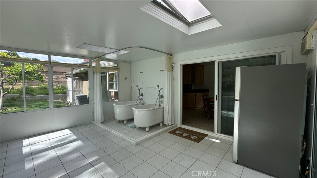 12111 Eddleston Drive Porter Ranch, CA 91326 - Photo 23 of 31 a spacious bathroom with a glass shower door and a window