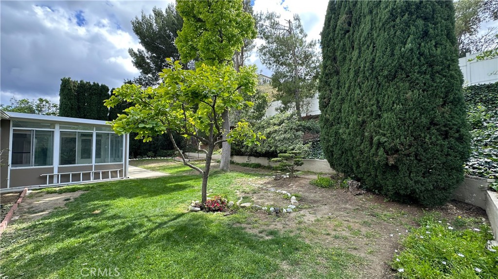 12111 Eddleston Drive Porter Ranch, CA 91326 - Photo 30 of 31 a view of a backyard with a garden