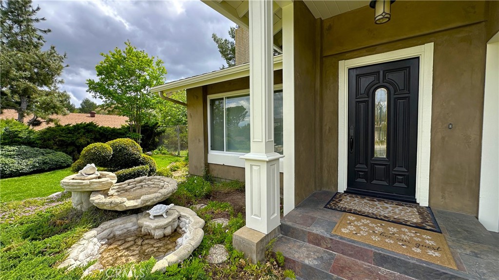 12111 Eddleston Drive Porter Ranch, CA 91326 - Photo 4 of 31 a view of a porch with chairs and potted plants