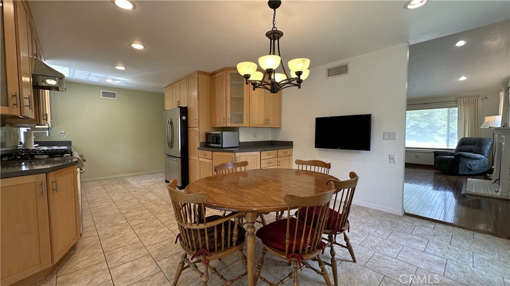 12111 Eddleston Drive Porter Ranch, CA 91326 - Photo 8 of 31 a view of a dining room with furniture and wooden floor