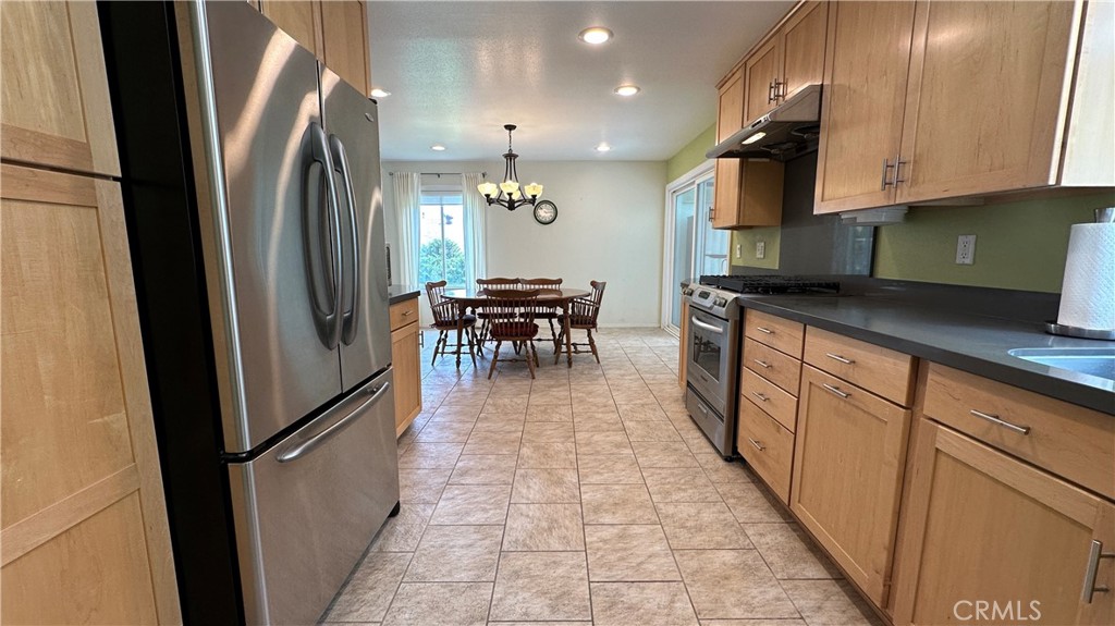 12111 Eddleston Drive Porter Ranch, CA 91326 - Photo 10 of 31 an open kitchen with granite countertop a sink appliances cabinets and a counter top space