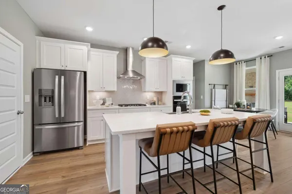 a dining table chair wooden floor and kitchen view