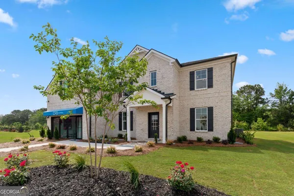 a front view of a house with garden