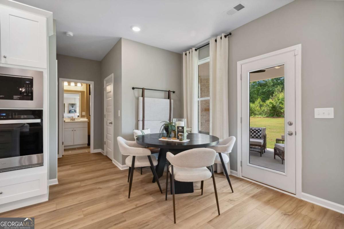 108 Compass Road Hampton, GA 30228 - Photo 21 of 51 a dining room with furniture and wooden floor