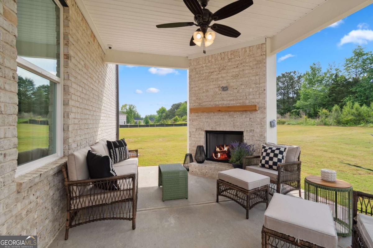 108 Compass Road Hampton, GA 30228 - Photo 22 of 51 a outdoor living space with furniture and a fireplace