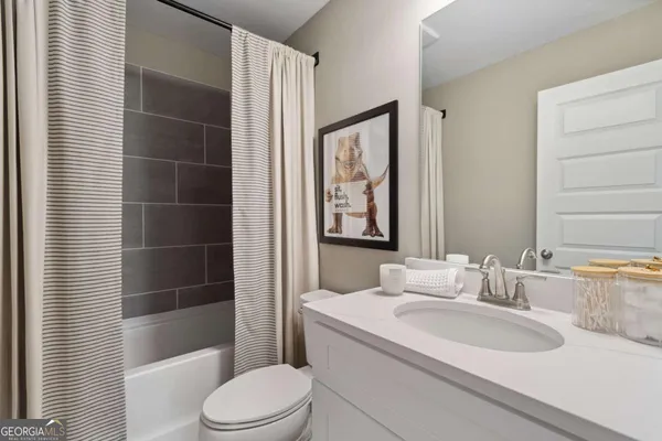 a bedroom with furniture and a large window