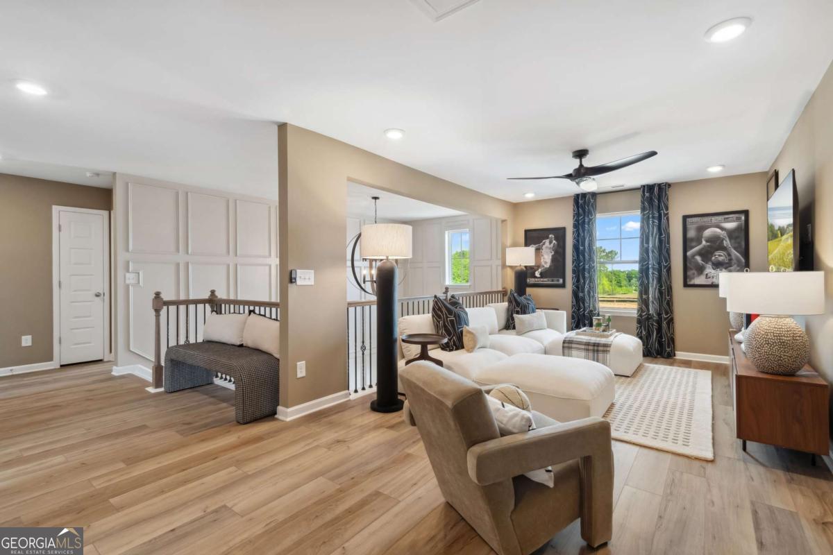 108 Compass Road Hampton, GA 30228 - Photo 33 of 51 a living room with furniture a dining table and wooden floor